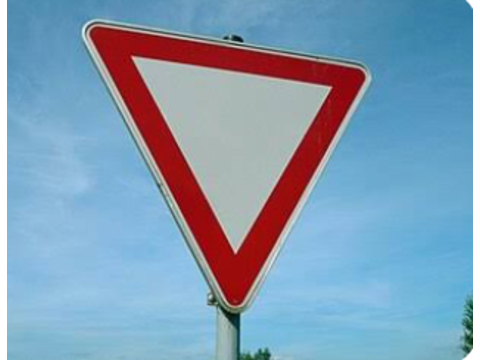 Yield the right of way to approaching traffic and all pedestrians at the intersection — Alberta right-of-way road sign for Class 7 test